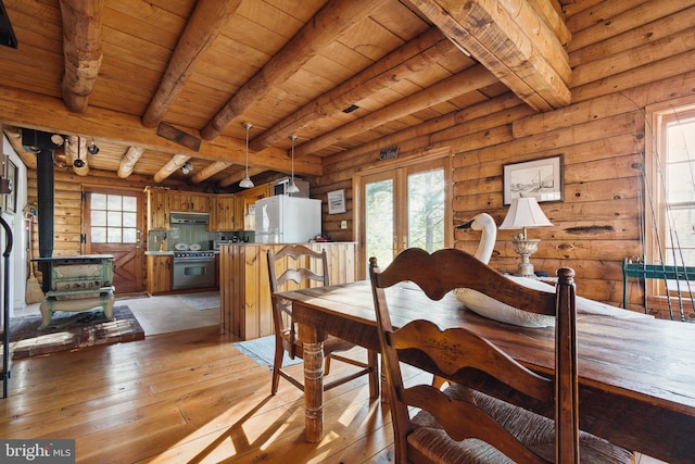 dining space with french doors, beam ceiling, log walls, light hardwood / wood-style floors, and wood ceiling