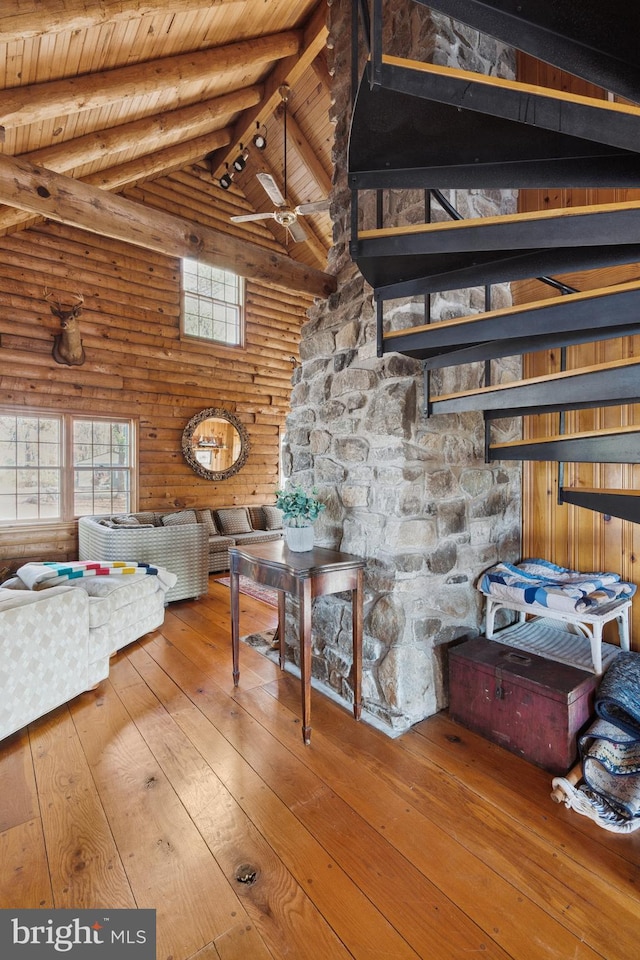 interior space featuring ceiling fan, high vaulted ceiling, beamed ceiling, wood ceiling, and hardwood / wood-style flooring