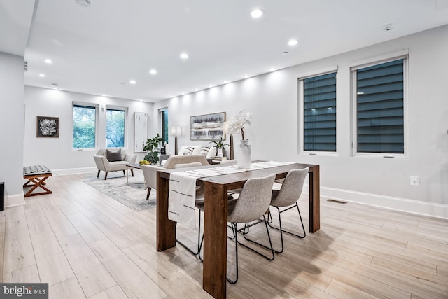 dining space featuring light wood-type flooring