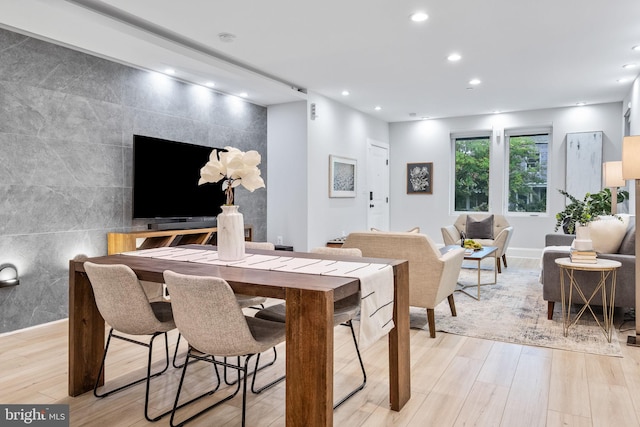 interior space with light wood-type flooring and tile walls