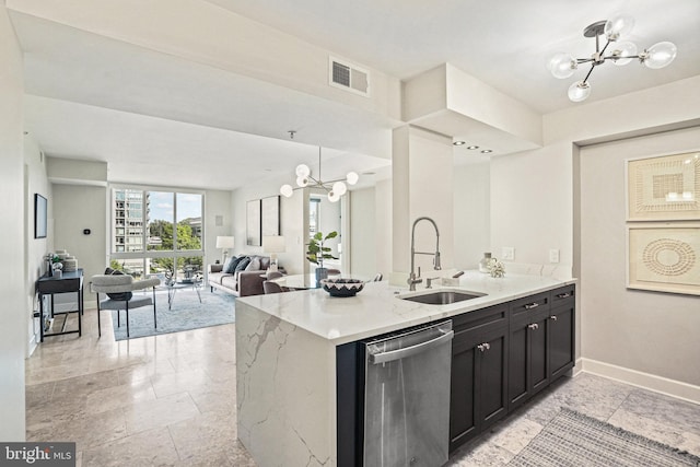 kitchen with an inviting chandelier, sink, stainless steel dishwasher, light stone counters, and kitchen peninsula