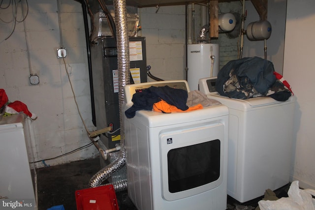 laundry area with gas water heater and separate washer and dryer