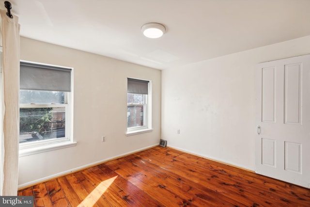 unfurnished room with hardwood / wood-style flooring