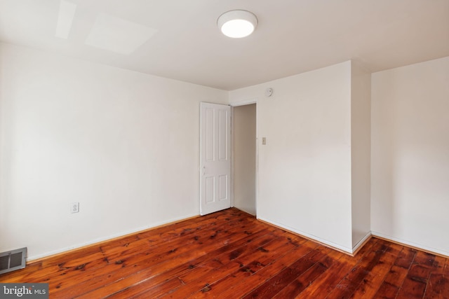 empty room with dark hardwood / wood-style floors