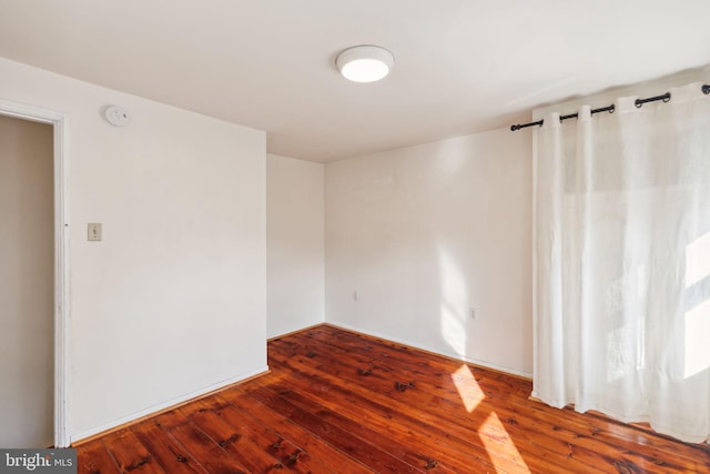 empty room with hardwood / wood-style flooring