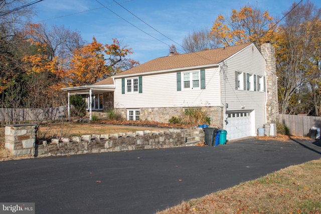 view of front of property with a porch and a garage