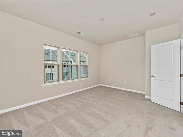 unfurnished room with light carpet