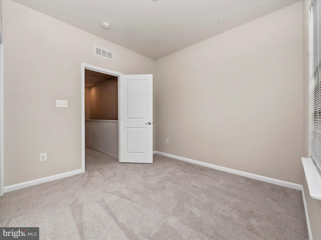 unfurnished bedroom featuring light carpet