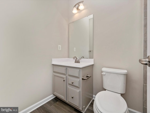 bathroom featuring hardwood / wood-style floors, vanity, and toilet