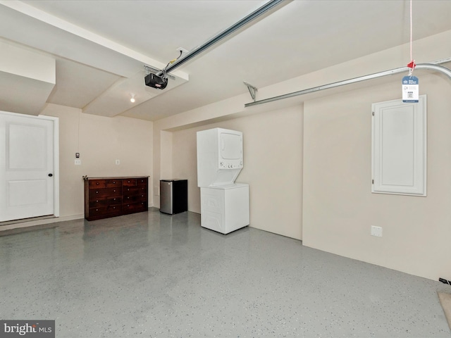 garage featuring a garage door opener and stacked washer and clothes dryer