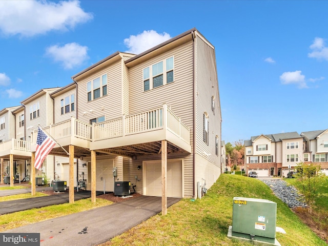 view of front of home with a garage and central AC unit