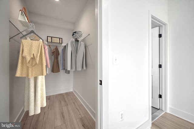 walk in closet featuring light hardwood / wood-style flooring