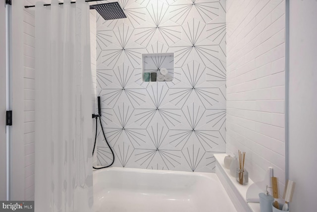 bathroom featuring shower / bath combination with curtain and tile walls