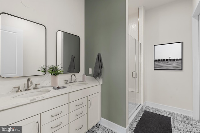 bathroom with vanity and a shower with door