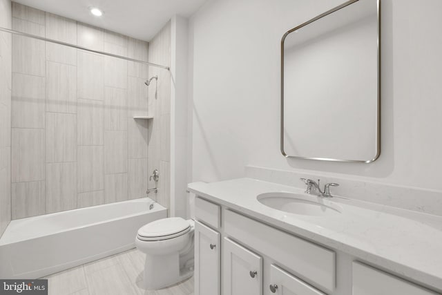 full bathroom featuring vanity, tiled shower / bath combo, and toilet