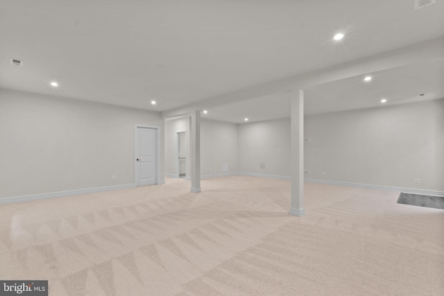 basement featuring light colored carpet