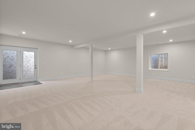 basement featuring light carpet