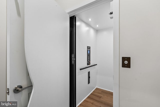 room details featuring hardwood / wood-style flooring and elevator