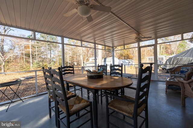 sunroom / solarium with ceiling fan, a healthy amount of sunlight, and wooden ceiling