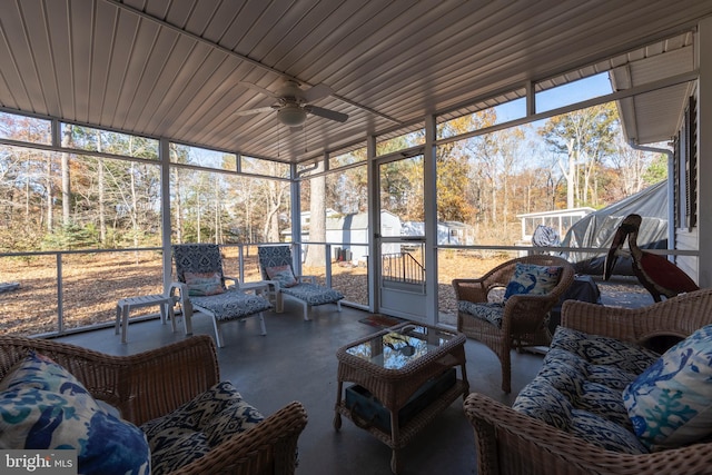 sunroom with ceiling fan, wooden ceiling, and a wealth of natural light