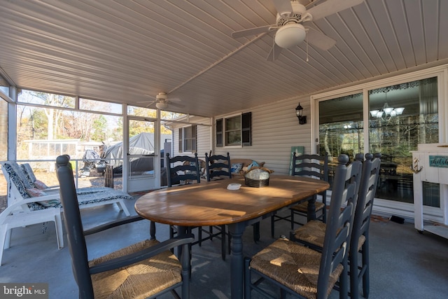 sunroom / solarium with ceiling fan with notable chandelier and wood ceiling