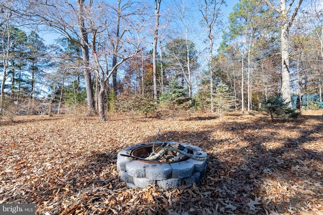 view of yard with a fire pit