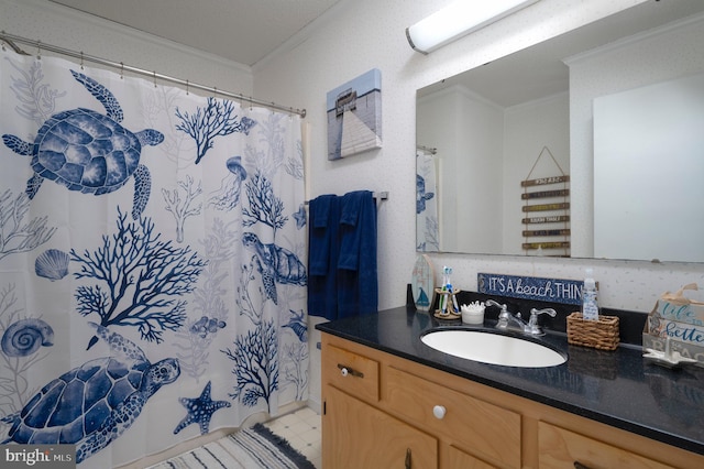 bathroom featuring curtained shower, vanity, and ornamental molding