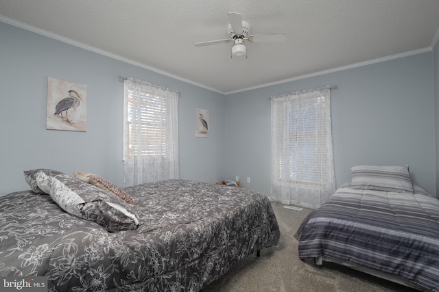 bedroom with a textured ceiling, ceiling fan, carpet floors, and crown molding