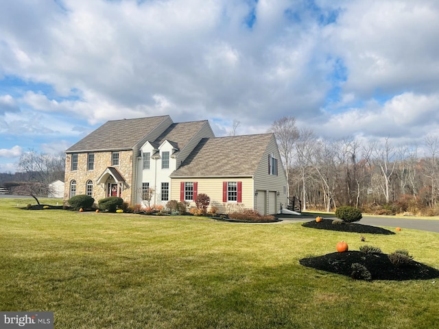 view of front facade with a front yard and a garage