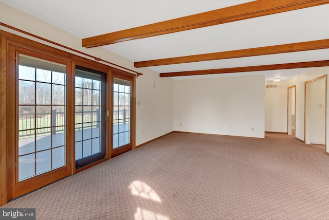 carpeted spare room with beam ceiling