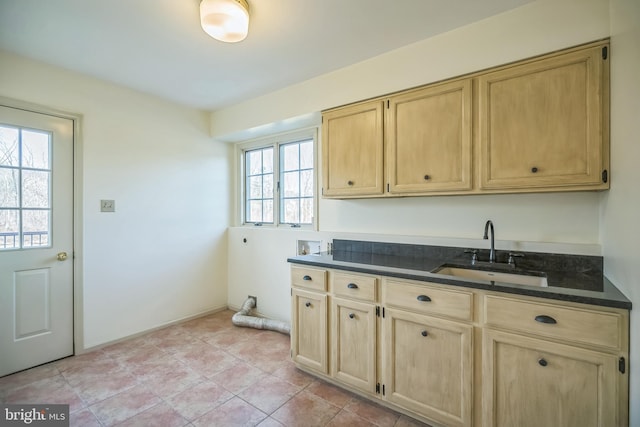 kitchen featuring a healthy amount of sunlight, light tile patterned floors, sink, and light brown cabinets