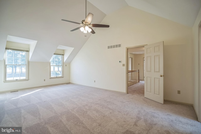 bonus room with ceiling fan, light colored carpet, and high vaulted ceiling