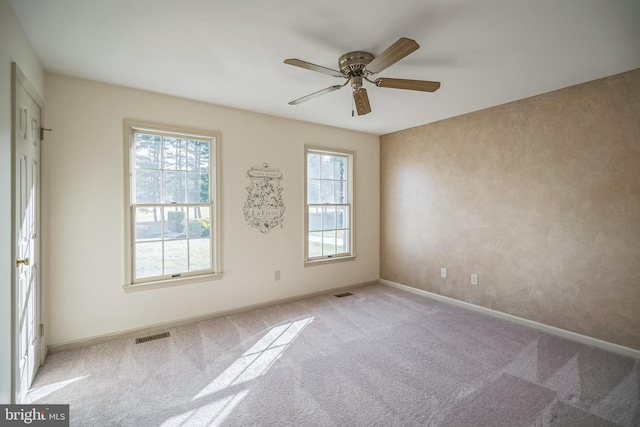 empty room featuring light carpet and ceiling fan