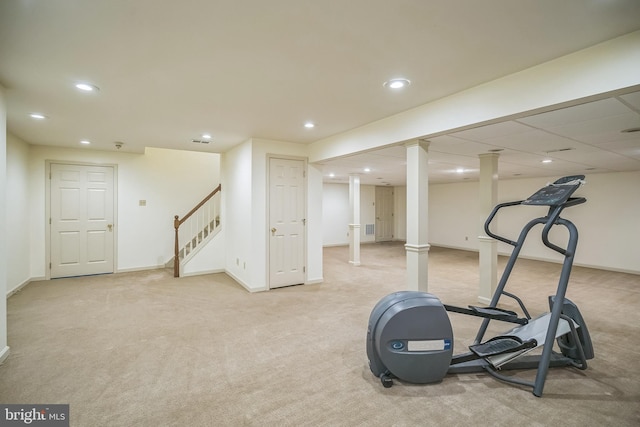 exercise room featuring light colored carpet