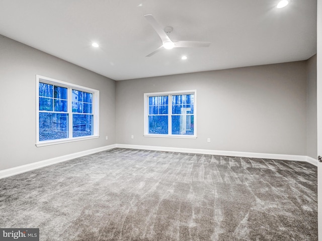 empty room featuring carpet flooring and ceiling fan