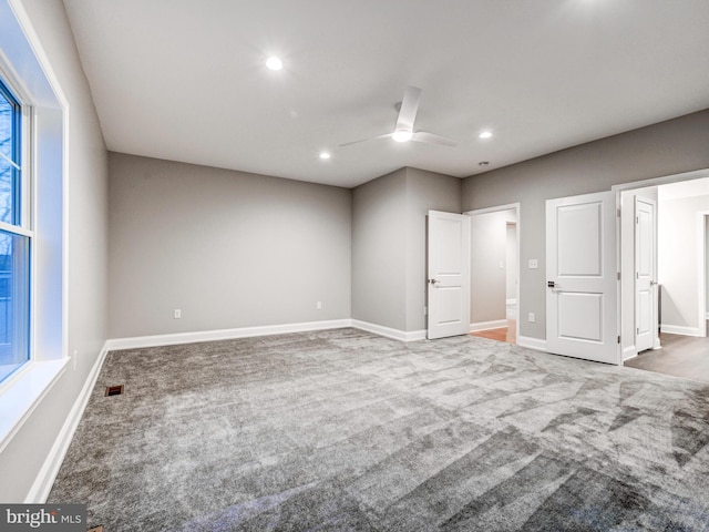 unfurnished bedroom featuring ceiling fan and carpet