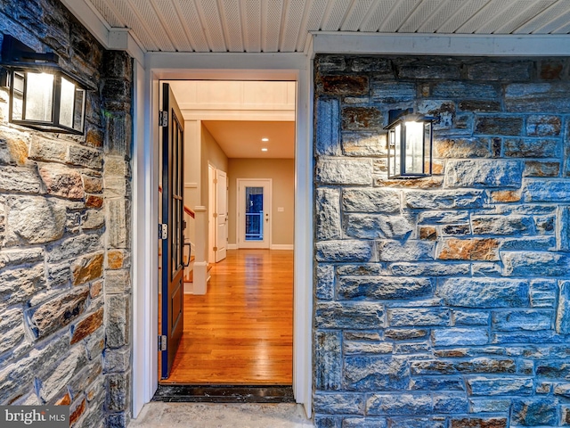 corridor with hardwood / wood-style floors