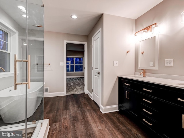 bathroom featuring a bathtub, vanity, and hardwood / wood-style flooring