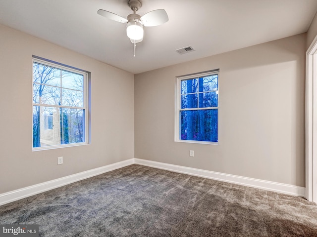 spare room featuring ceiling fan and carpet floors