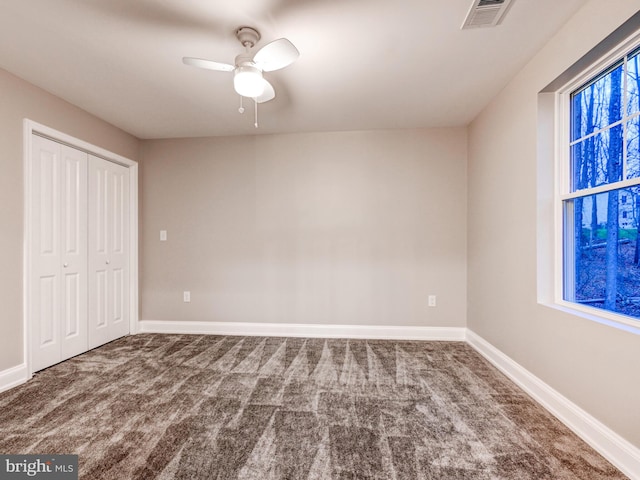 unfurnished bedroom featuring carpet flooring, ceiling fan, and a closet