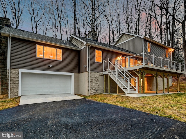 view of front of house with a garage and a deck