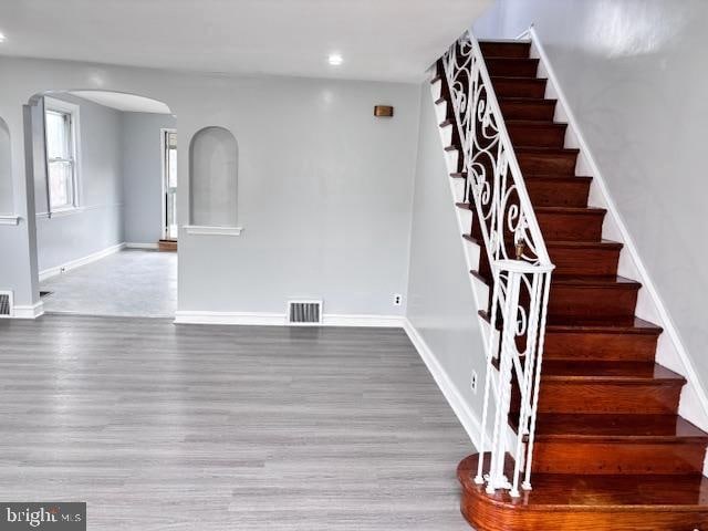 staircase with hardwood / wood-style floors