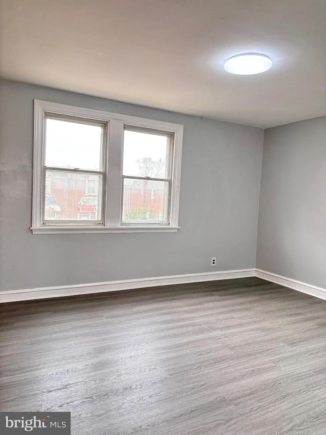 empty room with dark wood-type flooring