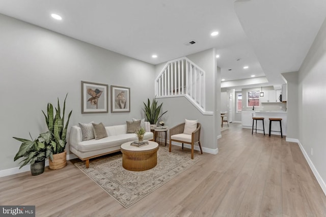 1645 Gorsuch Ave, Baltimore, MD 21218 - living room with light wood-style floors, recessed lighting, stairs, and baseboards
