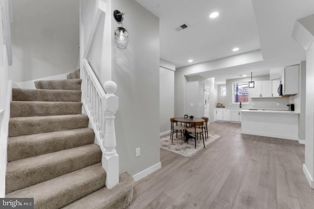 1645 Gorsuch Ave, Baltimore, MD 21218 - stairs with wood finished floors, baseboards, and recessed lighting