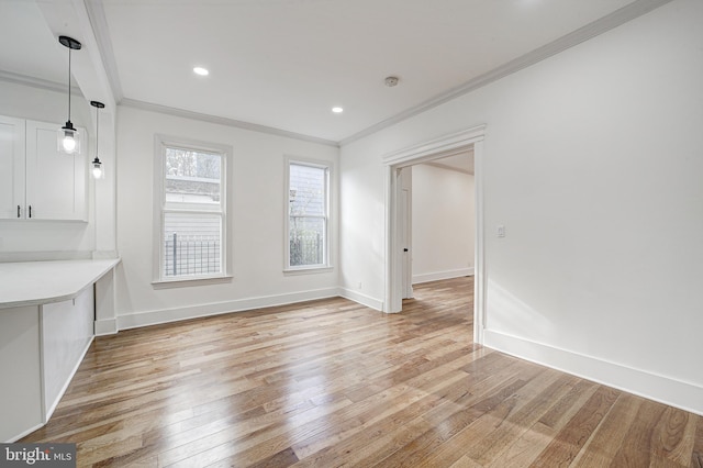 unfurnished dining area featuring hardwood / wood-style floors and crown molding