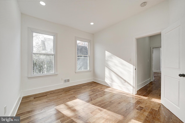 spare room featuring wood-type flooring