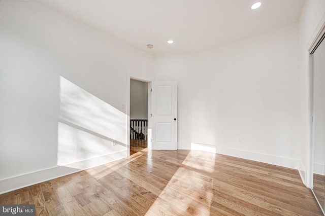 unfurnished room with wood-type flooring