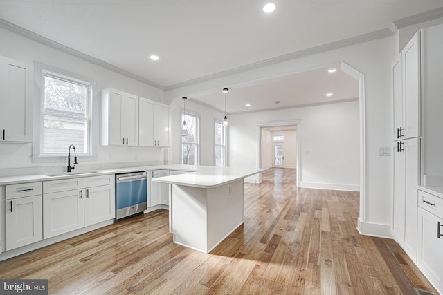 kitchen with dishwasher, sink, light hardwood / wood-style flooring, decorative light fixtures, and white cabinets