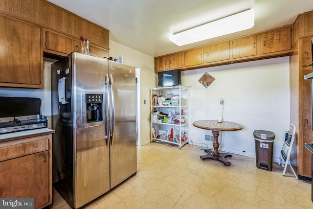 kitchen with stainless steel refrigerator with ice dispenser